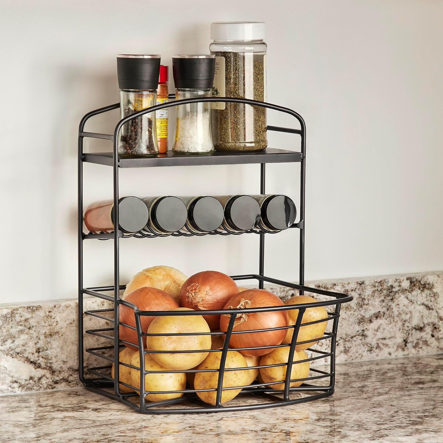 Countertop storage bin holding spices, onions and potatoes