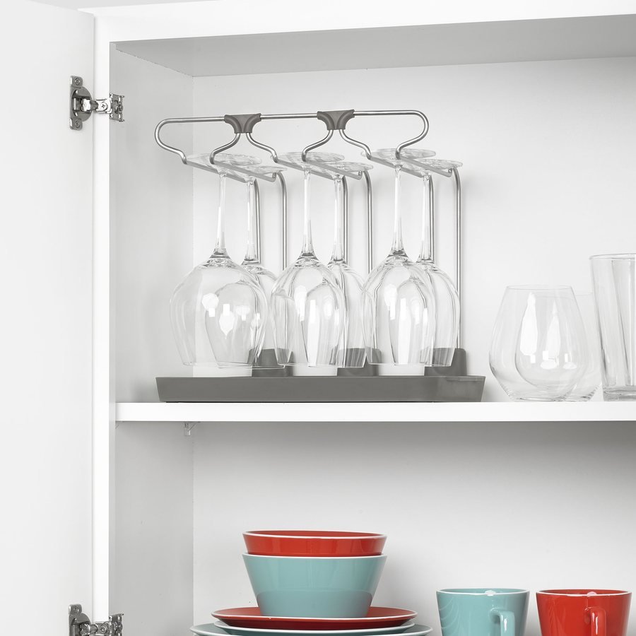 Wine glass drying rack holding stemware in a kitchen cabinet